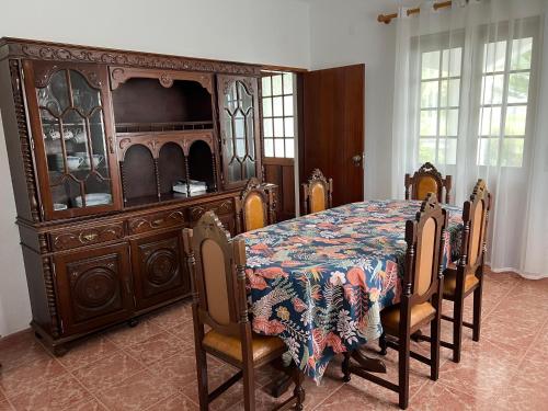 a large wooden bed with a table and chairs at Azul 31 in Lajes das Flores
