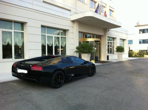 
a black car parked in front of a building at Hotel Marconi in Bentivoglio

