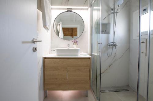 a bathroom with a sink and a mirror at Iliana Villas in Lefkada