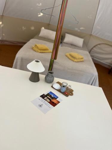 a white table with two beds in a room at Langø Fjord Glamping nr 3 in Nakskov