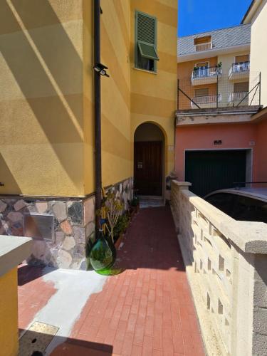 a building with a brick walkway in front of a building at La Casa di Nonna Mari in Moneglia