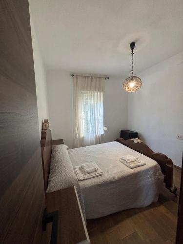 a bedroom with a bed and a window at El Mirador de Espadan in Alcudia de Veo
