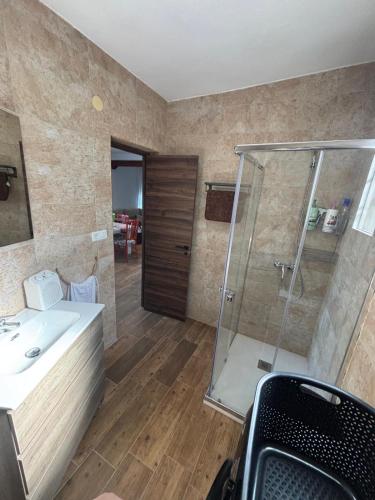 a bathroom with a sink and a glass shower at El Mirador de Espadan in Alcudia de Veo