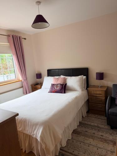 a bedroom with a large bed with a pillow on it at Oceanview B&B in Ringville
