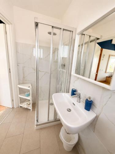 ein weißes Badezimmer mit Dusche und Waschbecken in der Unterkunft Hotel Aldebaran - Ideale per Gruppi - Marina Centro in Rimini
