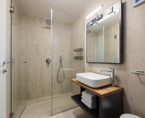 a bathroom with a sink and a shower at Villa ELENA Room Old Town in Rogoznica