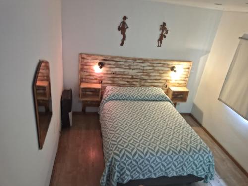 a small bedroom with a bed and a desk at JAP in Río Gallegos
