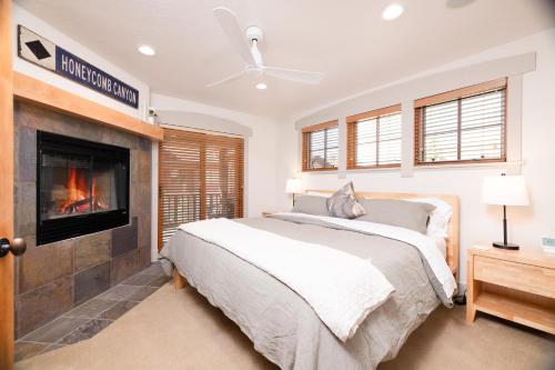 a bedroom with a bed and a fireplace at First Tracks Townhome in Solitude