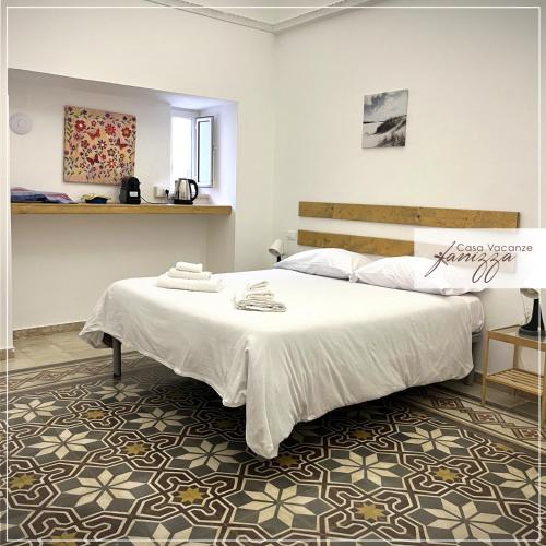 a bedroom with a large white bed in a room at Rebecca e Sofia Stone House affittacamere in Alberobello