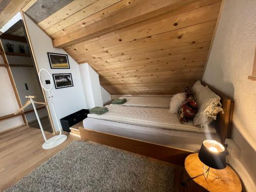 a bed in a room with a wooden ceiling at Vikend kuća Millina in Sumbulovac
