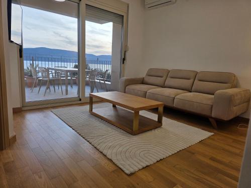 a living room with a couch and a coffee table at Stan Kumbor sa dvije spavace sobe in Kumbor