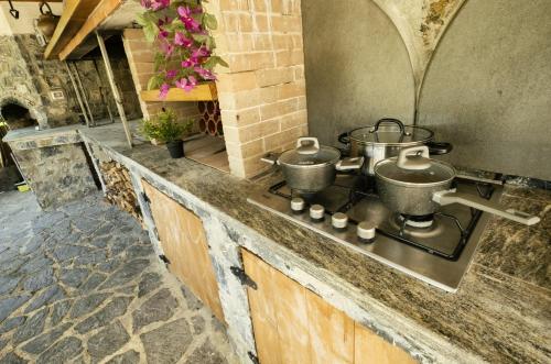 a kitchen with three pots on a stove at VILLA EMILY in Framura
