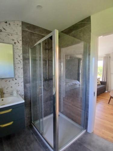 a bathroom with a shower and a sink at Meadow Suite in Lahinch