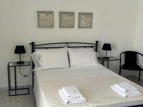 a bedroom with a bed with two towels on it at Kambi rooms in Himare
