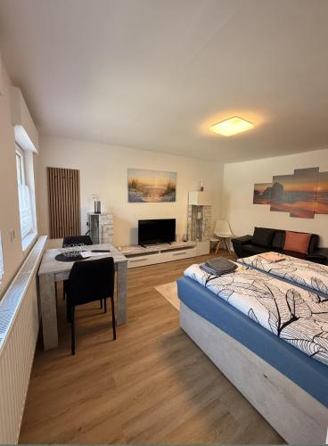 a bedroom with two beds and a table and a couch at Haus Kormoran Borkum in Borkum