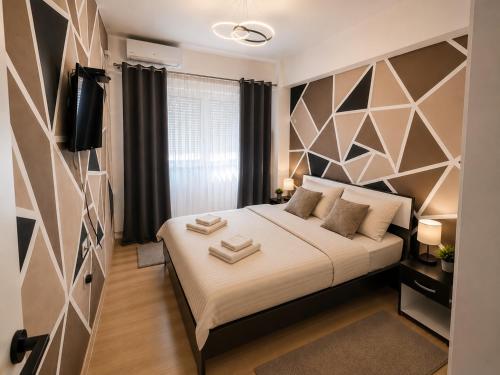a bedroom with a bed and a tv in a room at Apartment Moki in Skopje