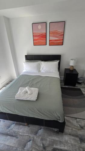 a bedroom with a bed with a towel on it at Stylish Townhome Gem with Several Amenities Just Minutes To The Falls in Niagara Falls