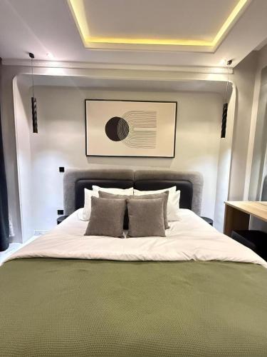 a bedroom with a large white bed with two pillows at Starella Apartments in Lekki