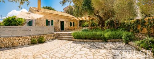 a house with a stone walkway in front of a yard at Private Villa Demetra 1768 with pool - close to Fiskardo in Fiskardo