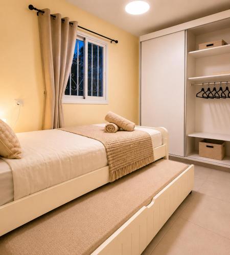 a bedroom with a bed and a window at Coastal Comfort in Haifa