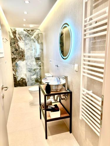 a bathroom with a sink and a toilet at The Corfu Urban Stays in Ágios Rókkos