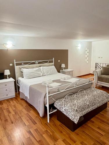 a bedroom with a large bed and a couch at Casa Bella - Ortigia & Neapolis in Syracuse