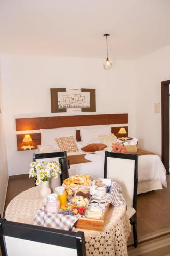 a room with a table with food on it at Pousada Medeiros in Monte Verde