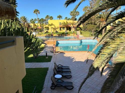 a view of a swimming pool in a resort at Corralejo Atlantic Garden Andrew apartments Pool air conditioning in Corralejo