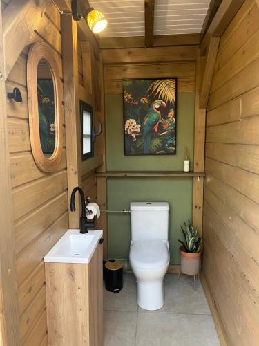 a bathroom with a toilet and a sink at Coco Banana in Baie-Mahault