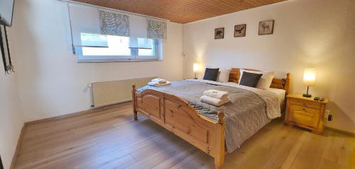 a bedroom with a bed with two towels on it at Ferienhaus am Seeblick Grill, Garten, Billiard, Dart, Bike, Sauna ww-Seeblick in Driedorf