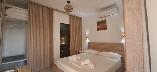 a bedroom with a white bed with white pillows at Hyka Stone House Shkoder in Shkodër