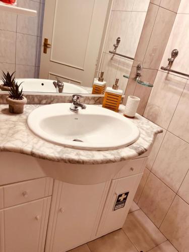 a white bathroom with a sink and a shower at Madeira Ocean View in Funchal