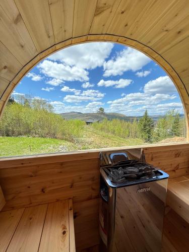 a kitchen with an arched window in a tiny house at Spa and Mountain - Chalet OslO42 in Saint Come