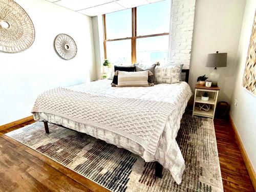 a bedroom with a large bed and a window at Lake Avenue Lofts- Cascade in Duluth