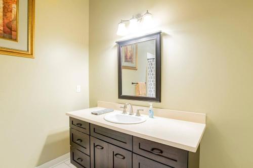 a bathroom with a sink and a mirror at Downtown Mobile Gem Steps from Cruise & Train Terminals in Mobile