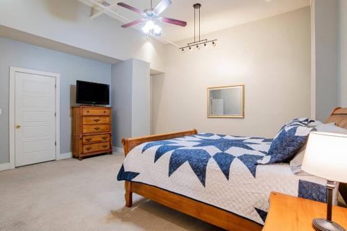 a bedroom with a bed and a ceiling fan at Downtown Mobile Gem Steps from Cruise & Train Terminals in Mobile