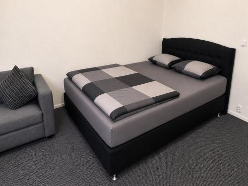 a bed and a couch in a room at Finstay Turku in Turku