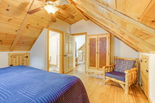 a bedroom with a blue bed and a chair at Secluded White River Haven! 4 Mi to Devil's Knob in Melbourne