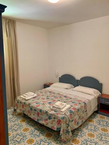 a hotel room with a bed with towels on it at Residence Antigua in Bonifati