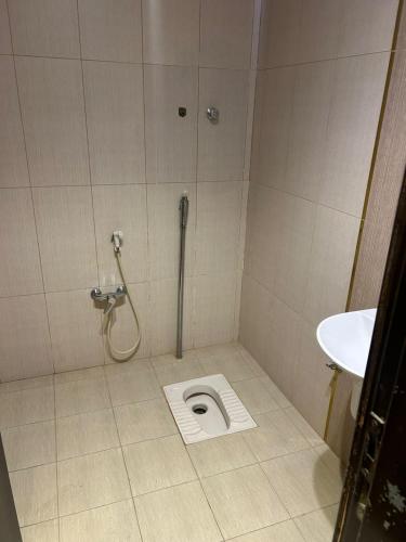 a bathroom stall with a toilet and a sink at شاليهات موج لاند 1 in Taif