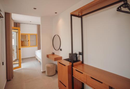 a bathroom with a dresser and a mirror in a room at IONEO Dhermi in Dhërmi