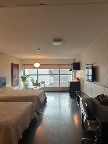 a hotel room with two beds and a television at MySuites in Montevideo