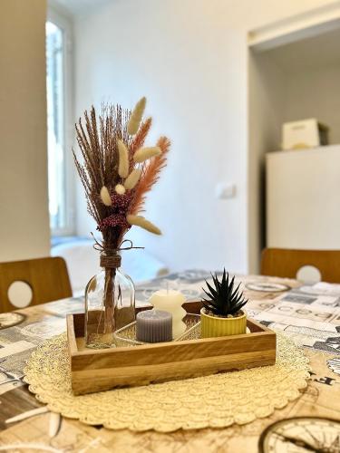 a table with a glass vase with flowers in it at Casa Garzoglio in Noli