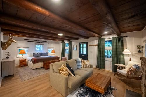 a large living room with a bed and a couch at The Woodsman Lodge in Eureka Springs