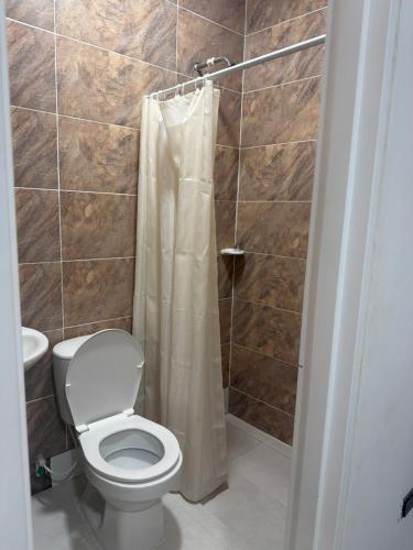 a bathroom with a toilet and a shower at Hotel Azulado - Como el mar in Jamundí