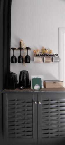 a black cabinet with two black pots on top of it at Casa Centro Suites Mykonos in Mikonos