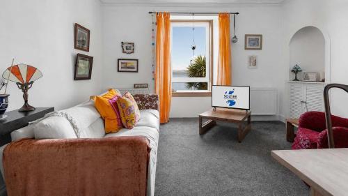 a living room with a couch and a window at Williams Haven in Rothesay