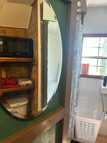 a mirror in a bathroom with a sink and a toilet at Swift Hollow Timeless Memories in Mountain City