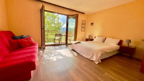 a bedroom with a bed and a couch and a window at Prespa Lakeview Villa in Resen