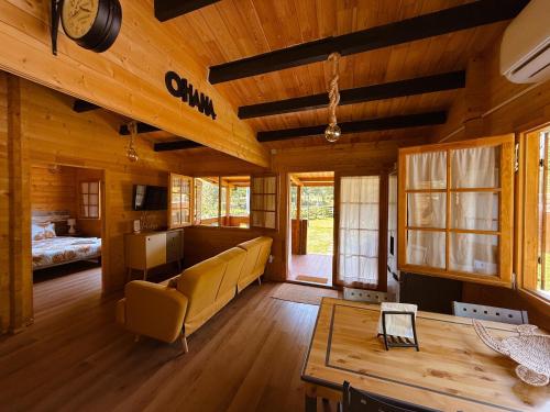 a living room with a couch and a table at Ohana Gerês House in Ruivãis